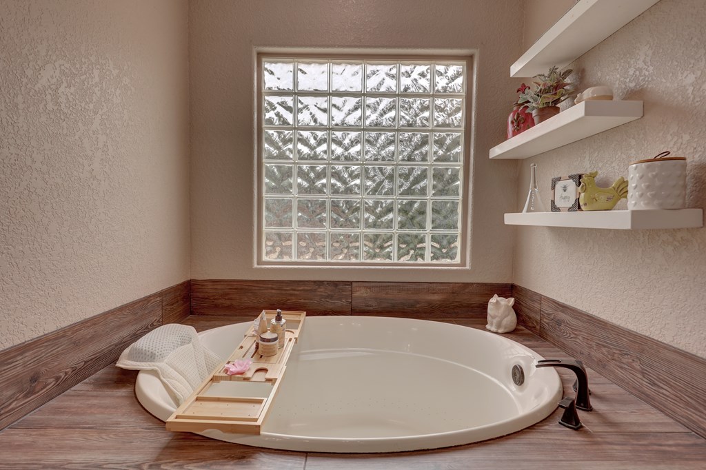 8177 Wendel Road Harper, TX 78631 - Photo 14 of 32 a white bath tub sitting in a bathroom next to a window