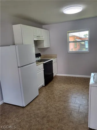 a kitchen with a refrigerator and a stove