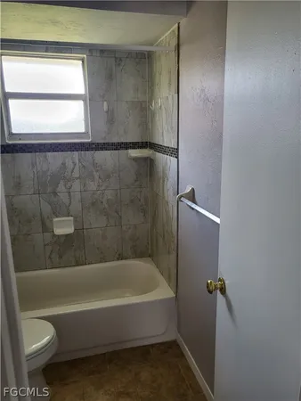 a bathroom with a bathtub and a toilet