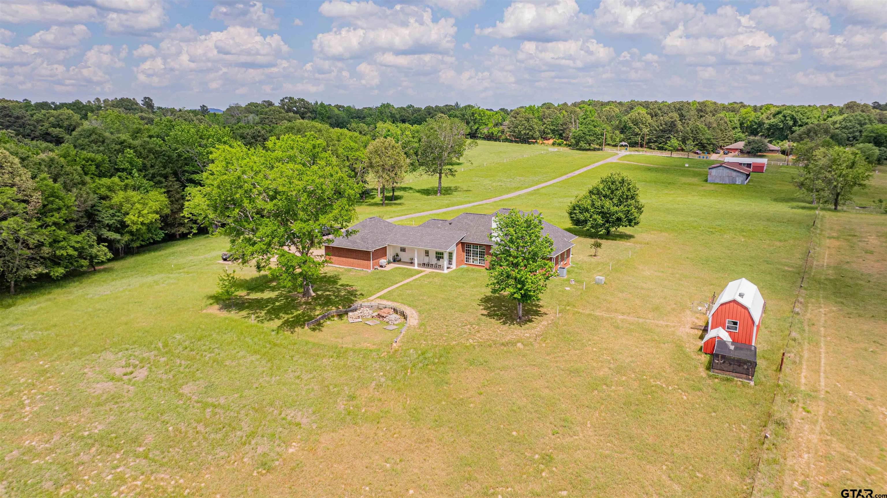 1855 Phillips Springs Road Gladewater, TX 75647 - Photo 25 of 36 a view of a lake with a building in the background