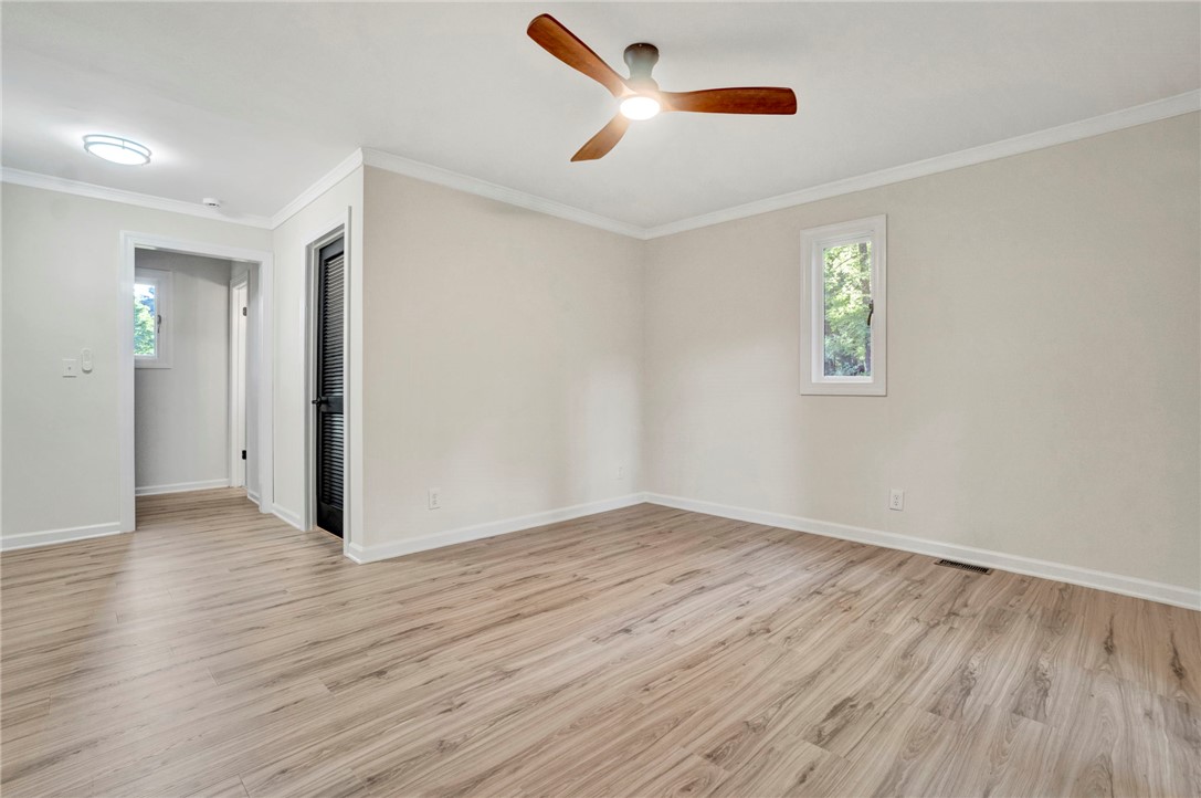 237 Earle Road Central, SC 29630 - Photo 13 of 24 A quiet retreat with fresh laminate flooring and a ceiling fan, offering a comfortable atmosphere.