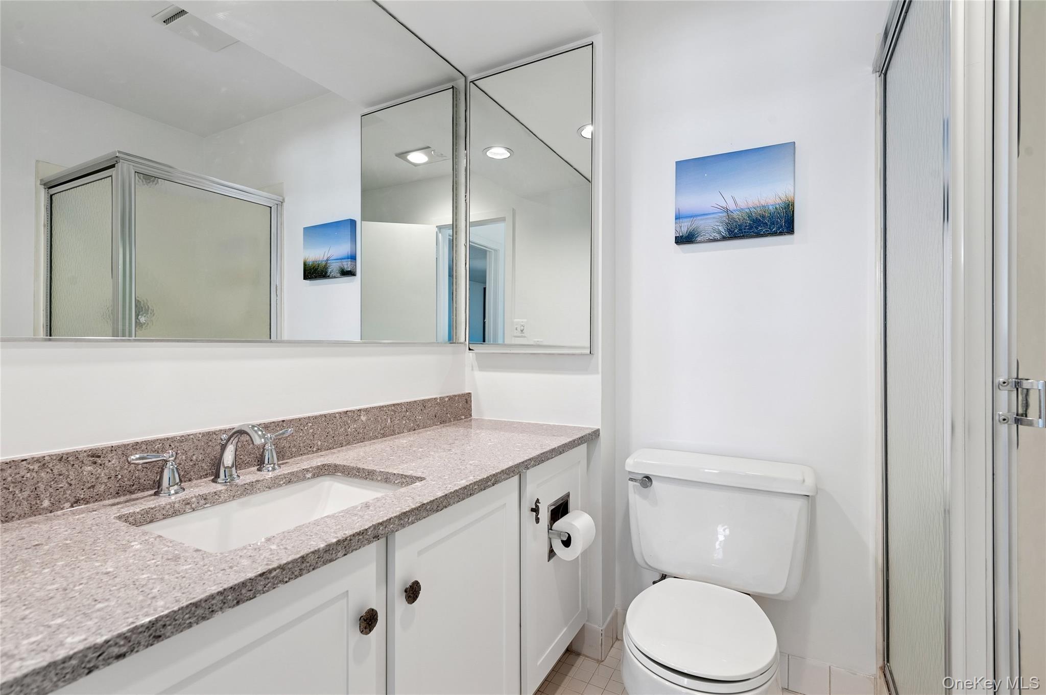 259 Dune Road, Unit 137 Westhampton Beach, NY 11978 - Photo 14 of 16 a bathroom with a granite countertop sink toilet and mirror