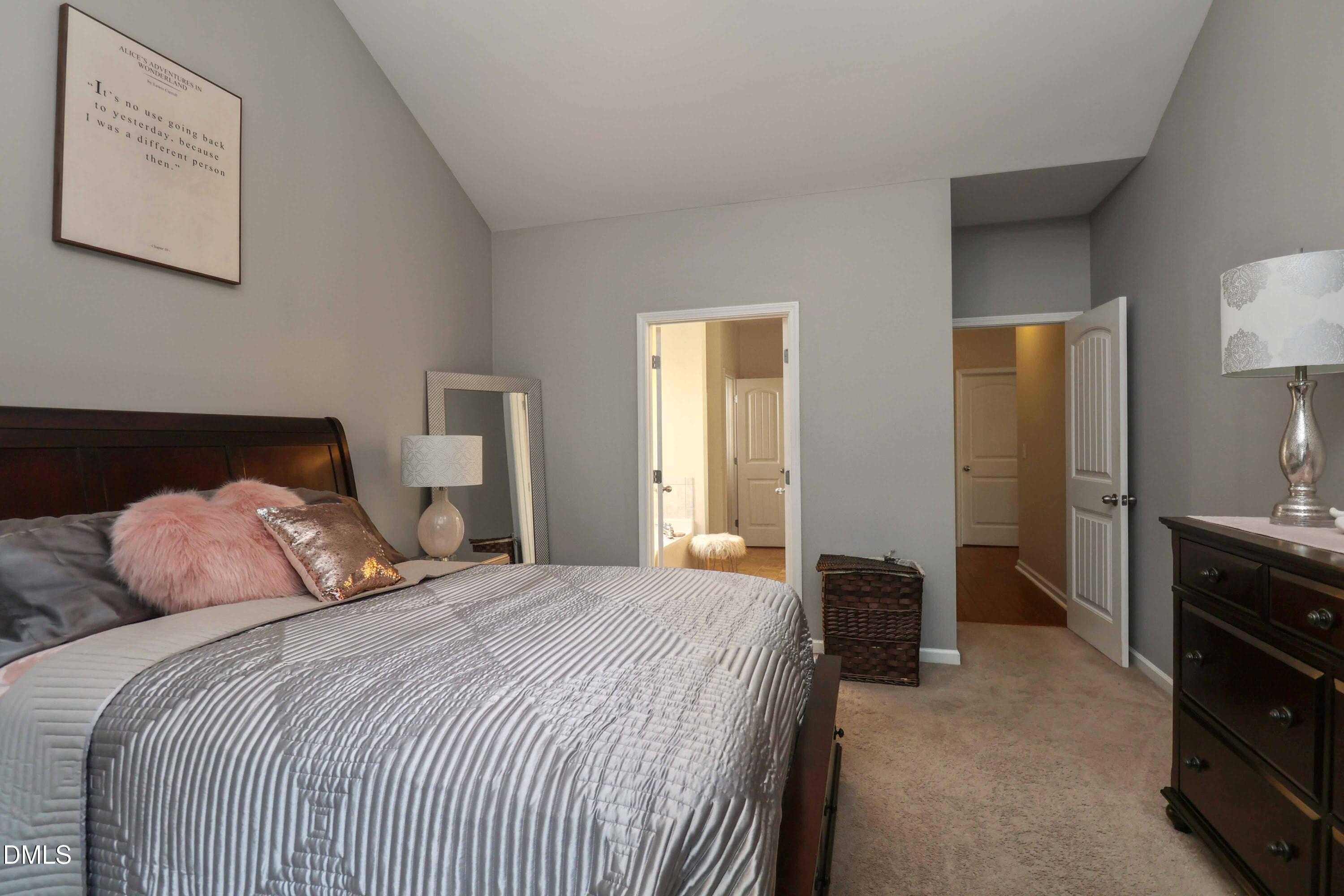 3152 Landing Falls Lane Raleigh, NC 27616 - Photo 13 of 29 a bedroom with a bed and a lamp