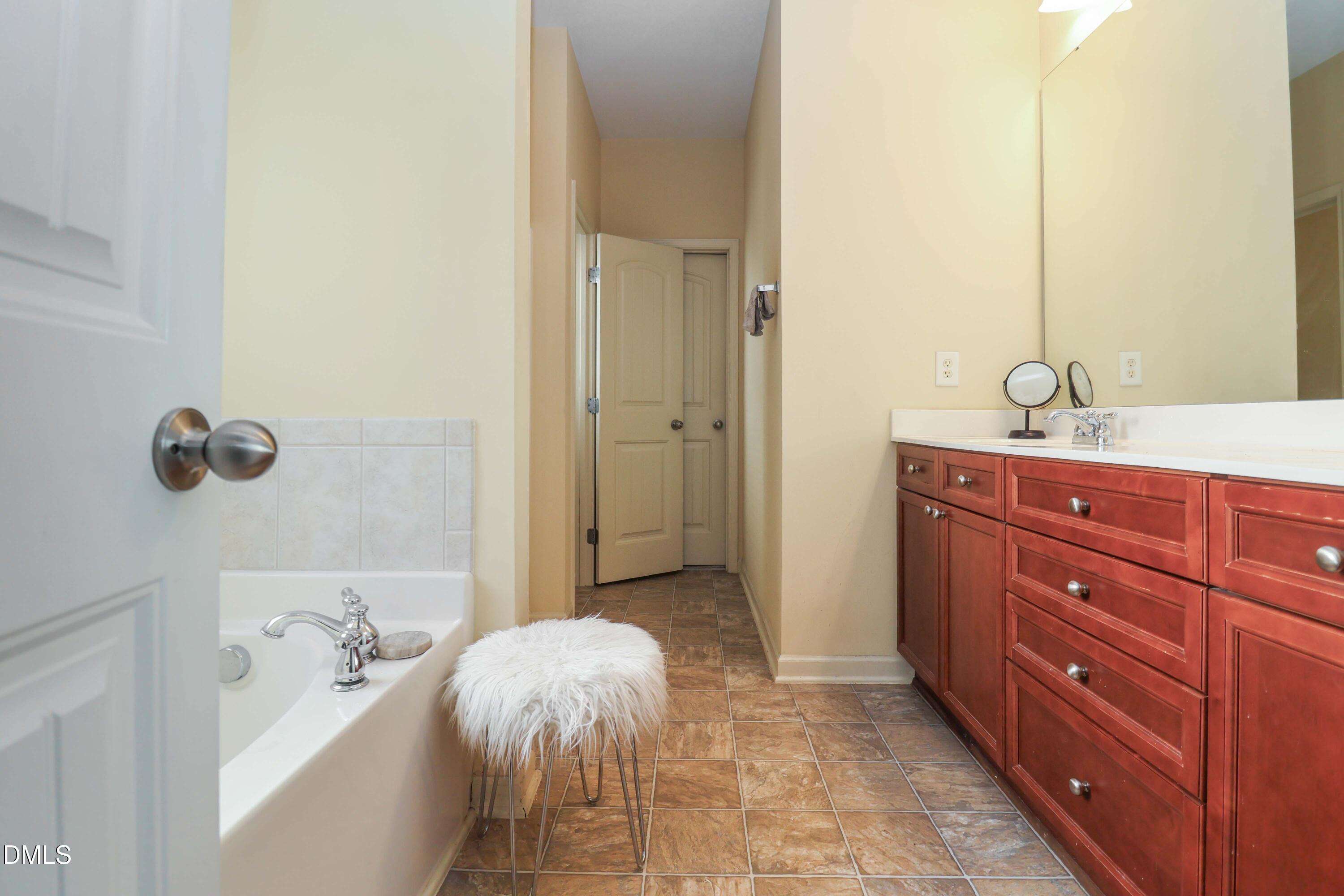 3152 Landing Falls Lane Raleigh, NC 27616 - Photo 14 of 29 a bathroom with a tub sink and mirror