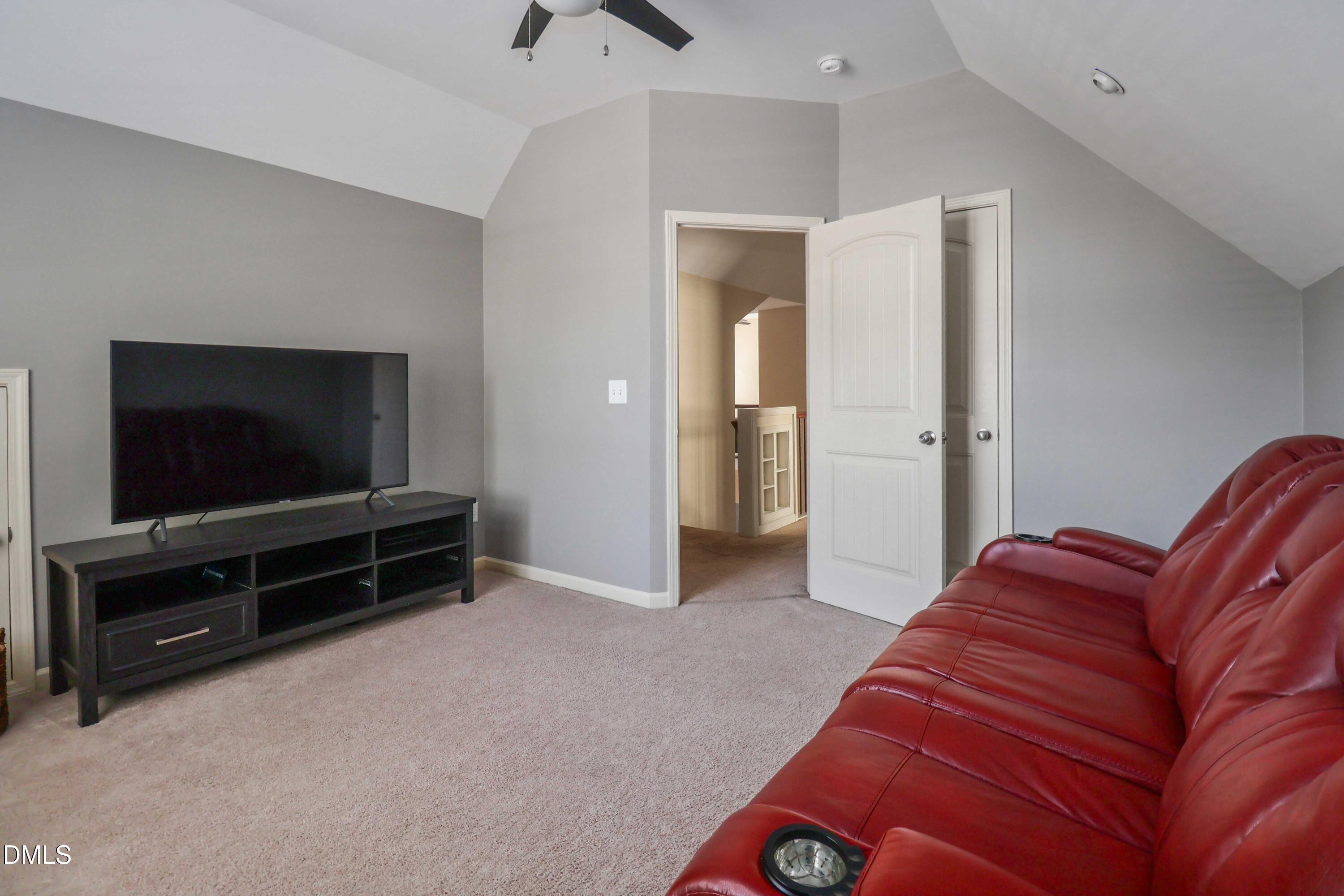 3152 Landing Falls Lane Raleigh, NC 27616 - Photo 18 of 29 a living room with a large couch and a flat screen tv