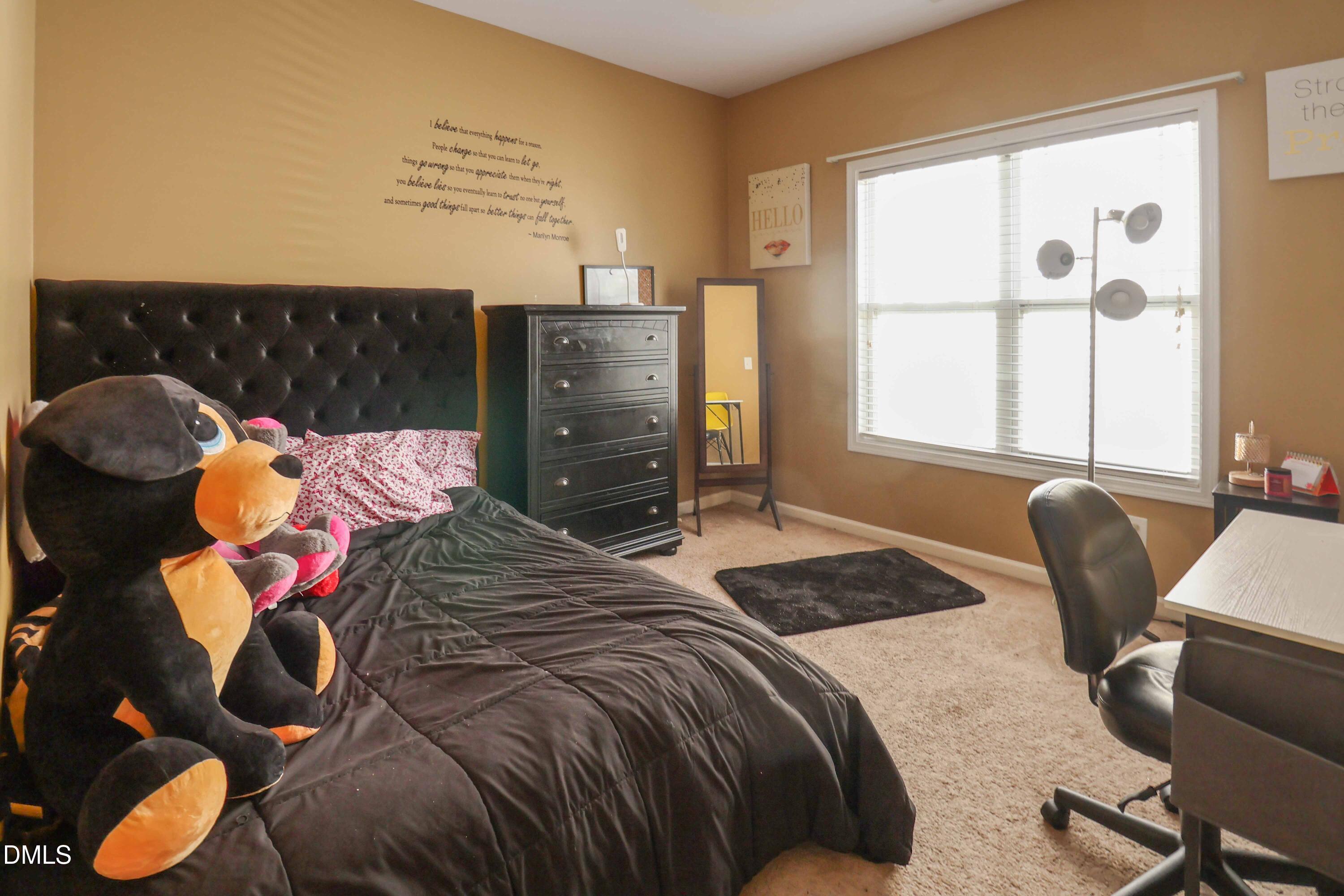 3152 Landing Falls Lane Raleigh, NC 27616 - Photo 20 of 29 a bedroom with a bed and a chair