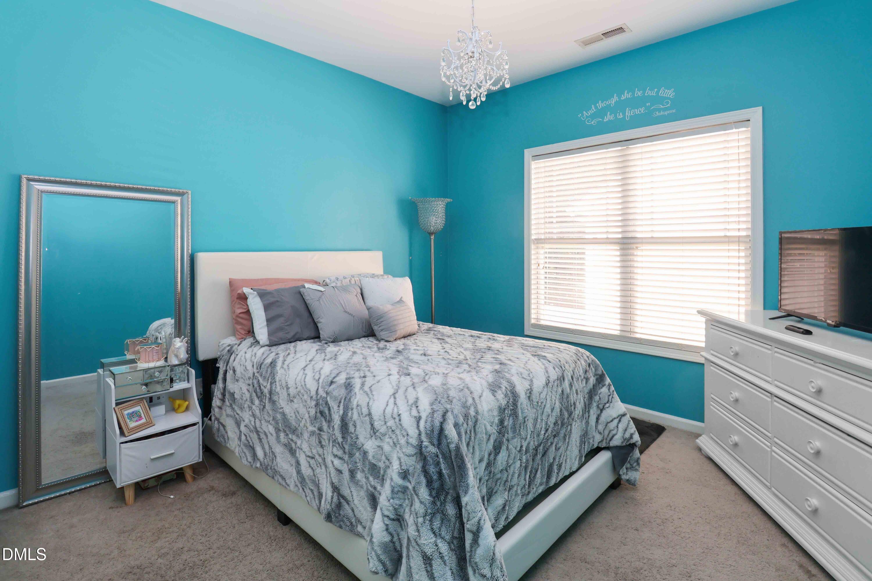 3152 Landing Falls Lane Raleigh, NC 27616 - Photo 21 of 29 a bed sitting in a bedroom next to a window