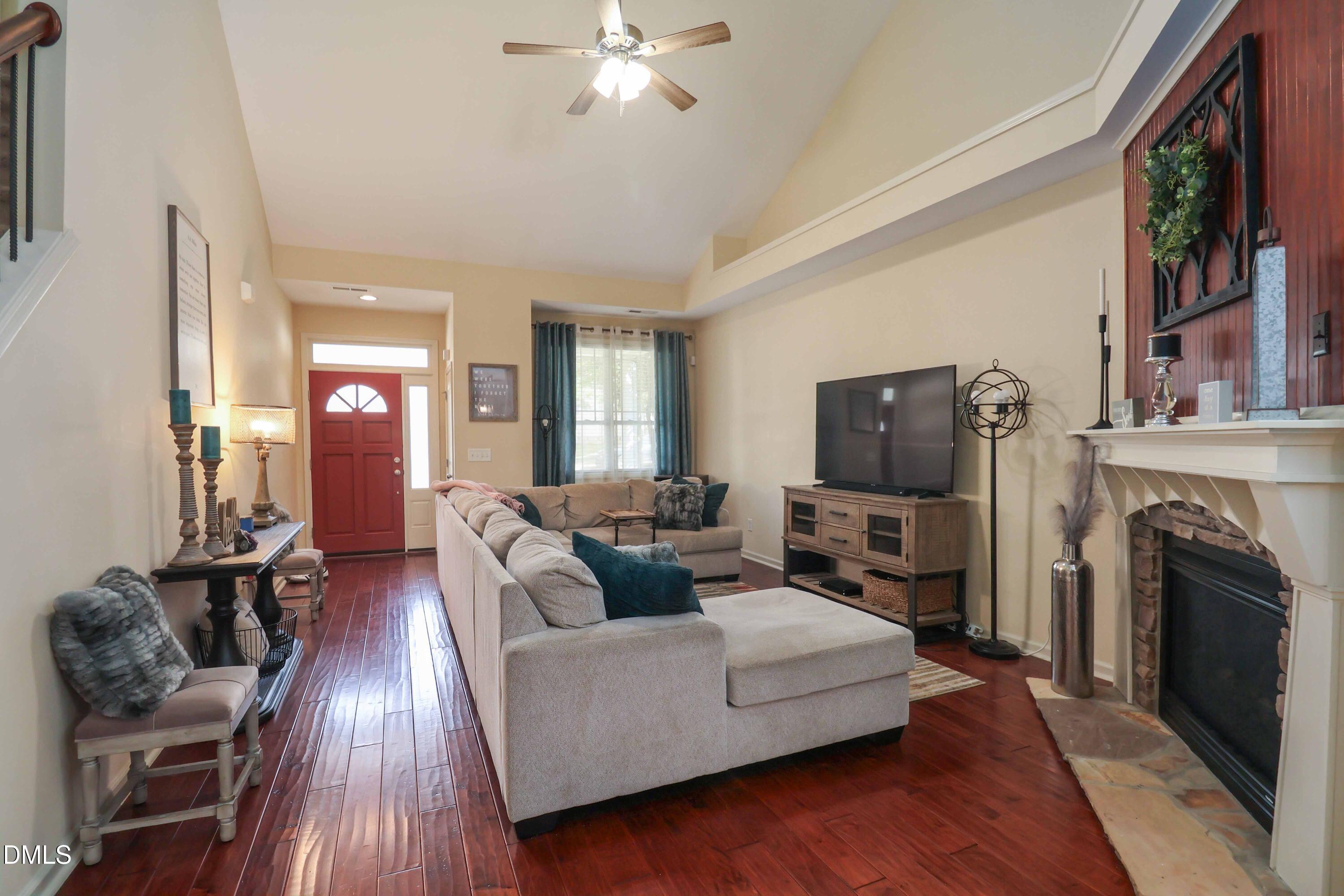 3152 Landing Falls Lane Raleigh, NC 27616 - Photo 3 of 29 a living room with furniture a fireplace and a flat screen tv