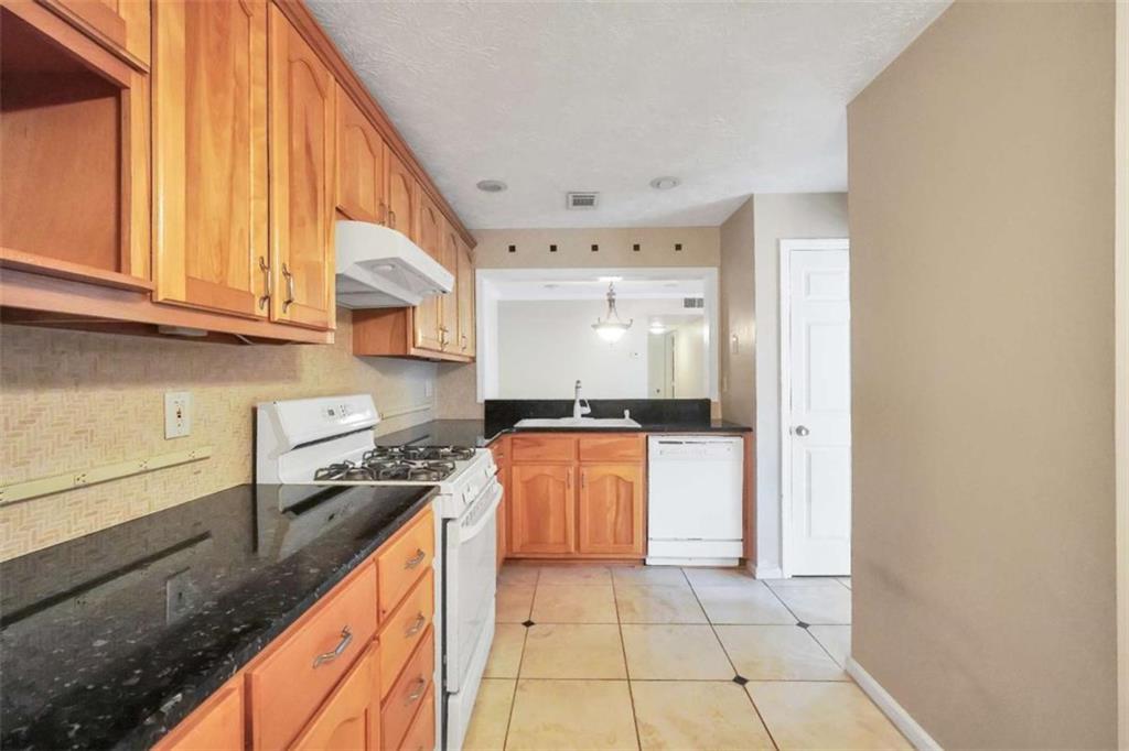 1482 North Crossing Circle Atlanta, GA 30329 - Photo 12 of 34 a kitchen with stainless steel appliances granite countertop a stove a sink and a refrigerator