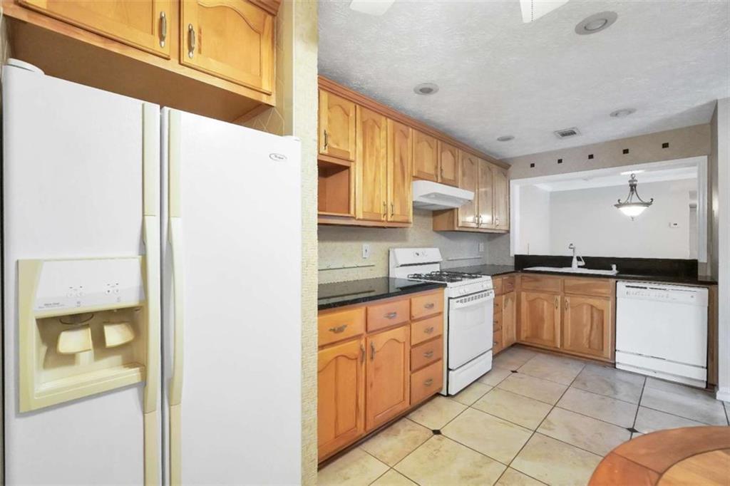 1482 North Crossing Circle Atlanta, GA 30329 - Photo 14 of 34 a kitchen with stainless steel appliances granite countertop a refrigerator and a stove top oven