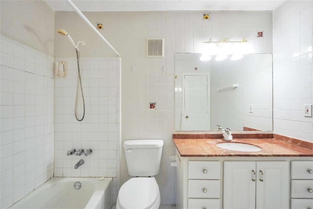 1482 North Crossing Circle Atlanta, GA 30329 - Photo 20 of 34 a bathroom with a granite countertop sink a toilet and shower