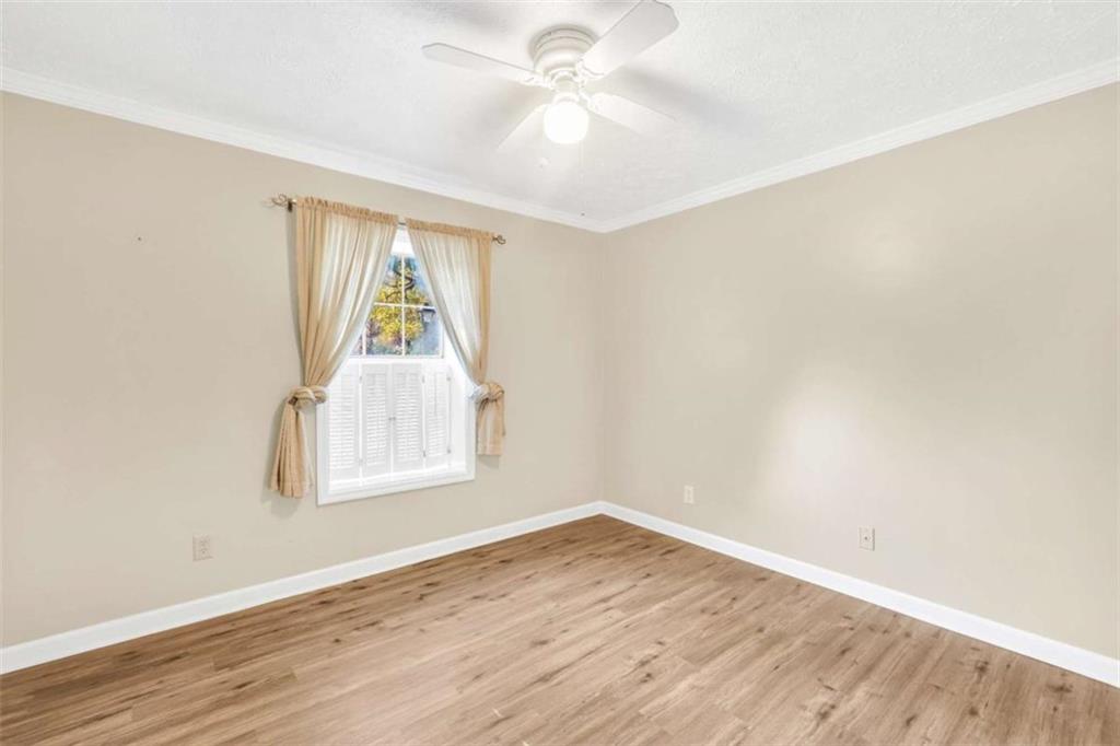 1482 North Crossing Circle Atlanta, GA 30329 - Photo 21 of 34 wooden floor in an empty room with a window