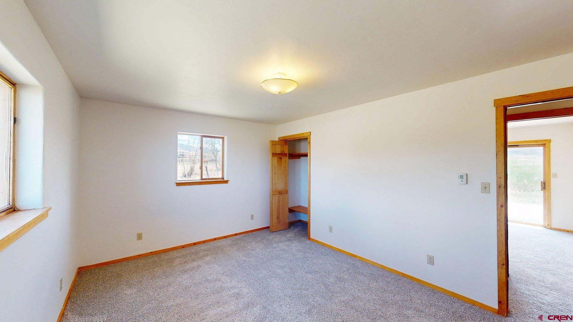 40557 M75 Road Paonia, CO 81428 - Photo 18 of 34 an empty room with a window and a hallway
