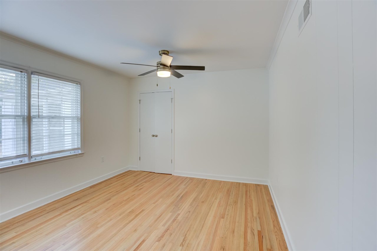 5541 Normandy Road Memphis, TN 38120 - Photo 14 of 21 wooden floor in an empty room with a window