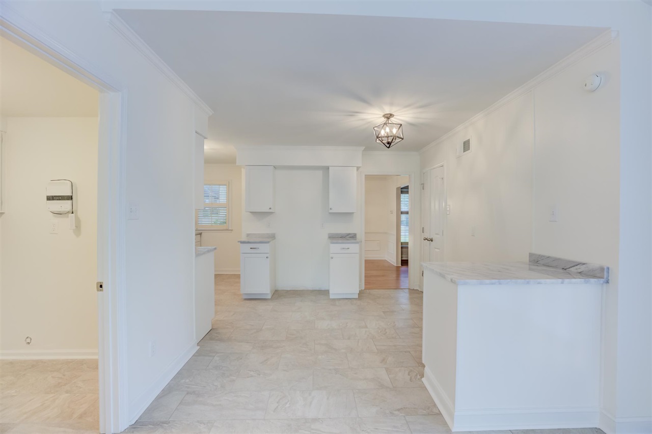 5541 Normandy Road Memphis, TN 38120 - Photo 8 of 21 a view of a kitchen with a sink and refrigerator in it