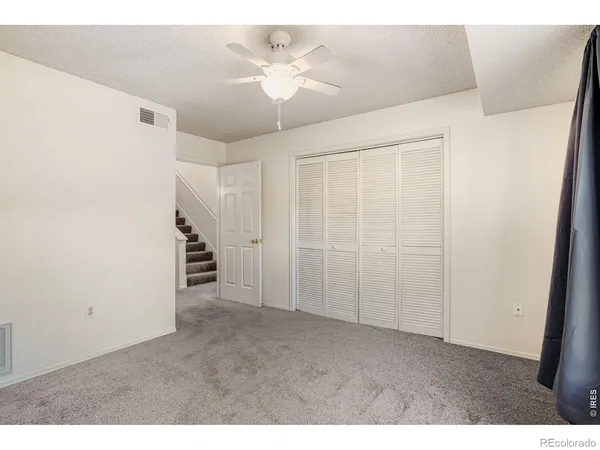 a view of an empty room with a ceiling fan