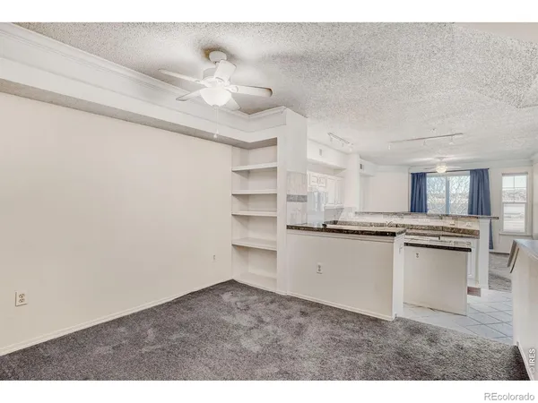 a kitchen with cabinets wooden floor and stainless steel appliances