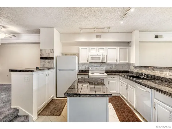 a kitchen with a refrigerator and a stove