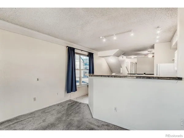 a view of a living room and kitchen