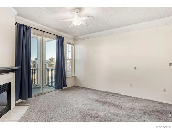 a view of an empty room with a fireplace