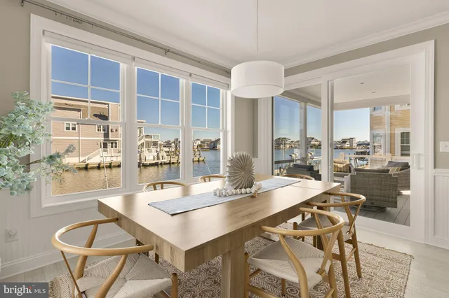 a dining room with furniture a chandelier and wooden floor