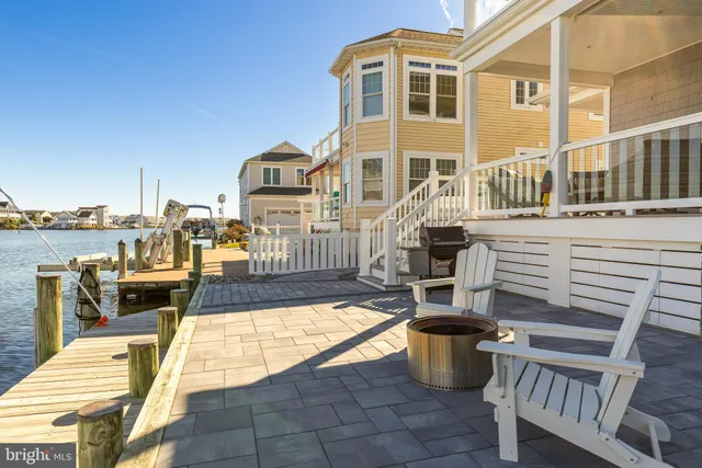 a view of a patio with couches chairs and wooden floor