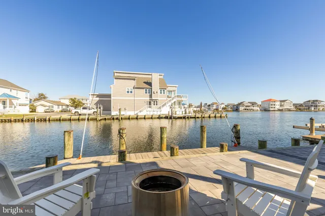 a view of a lake with couches chairs