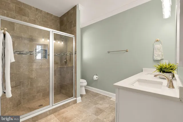 a bathroom with a shower and a sink