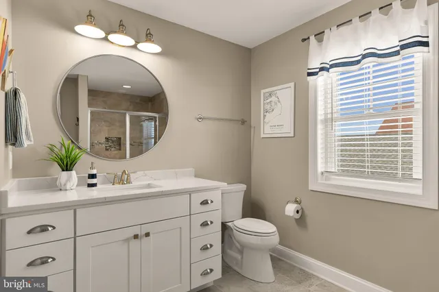 a bathroom with a toilet a sink and mirror