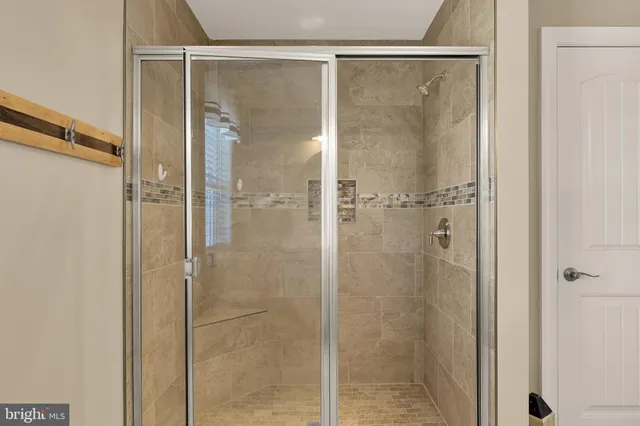 a bathroom with a glass shower door