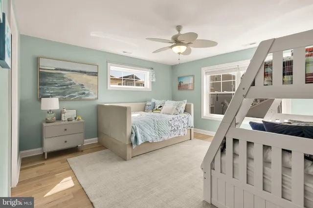 a spacious bedroom with a bed and a chandelier