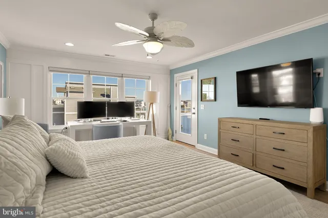 a bedroom with a bed a flat screen tv and a couch