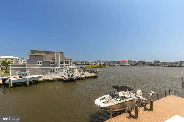 a view of a lake with boats and trees in the background