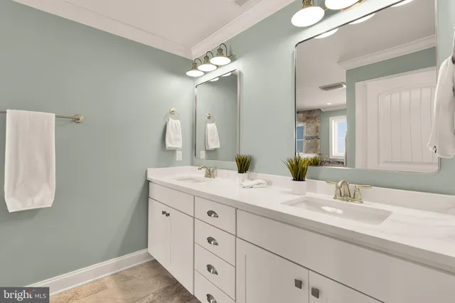 a bathroom with a double vanity sink and a mirror