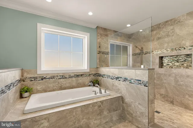 a bathroom with bathtub shower and window