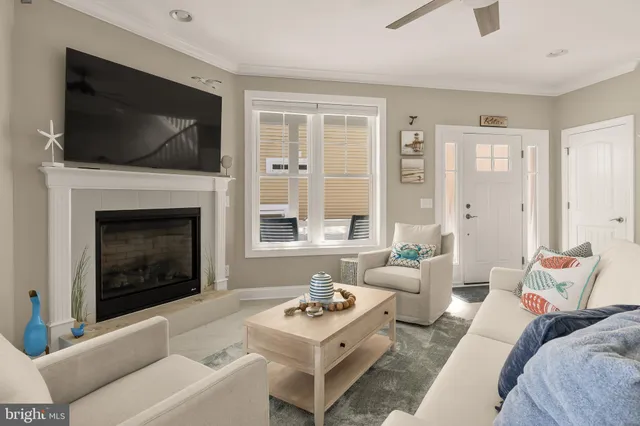 a living room with furniture a flat screen tv and a fireplace