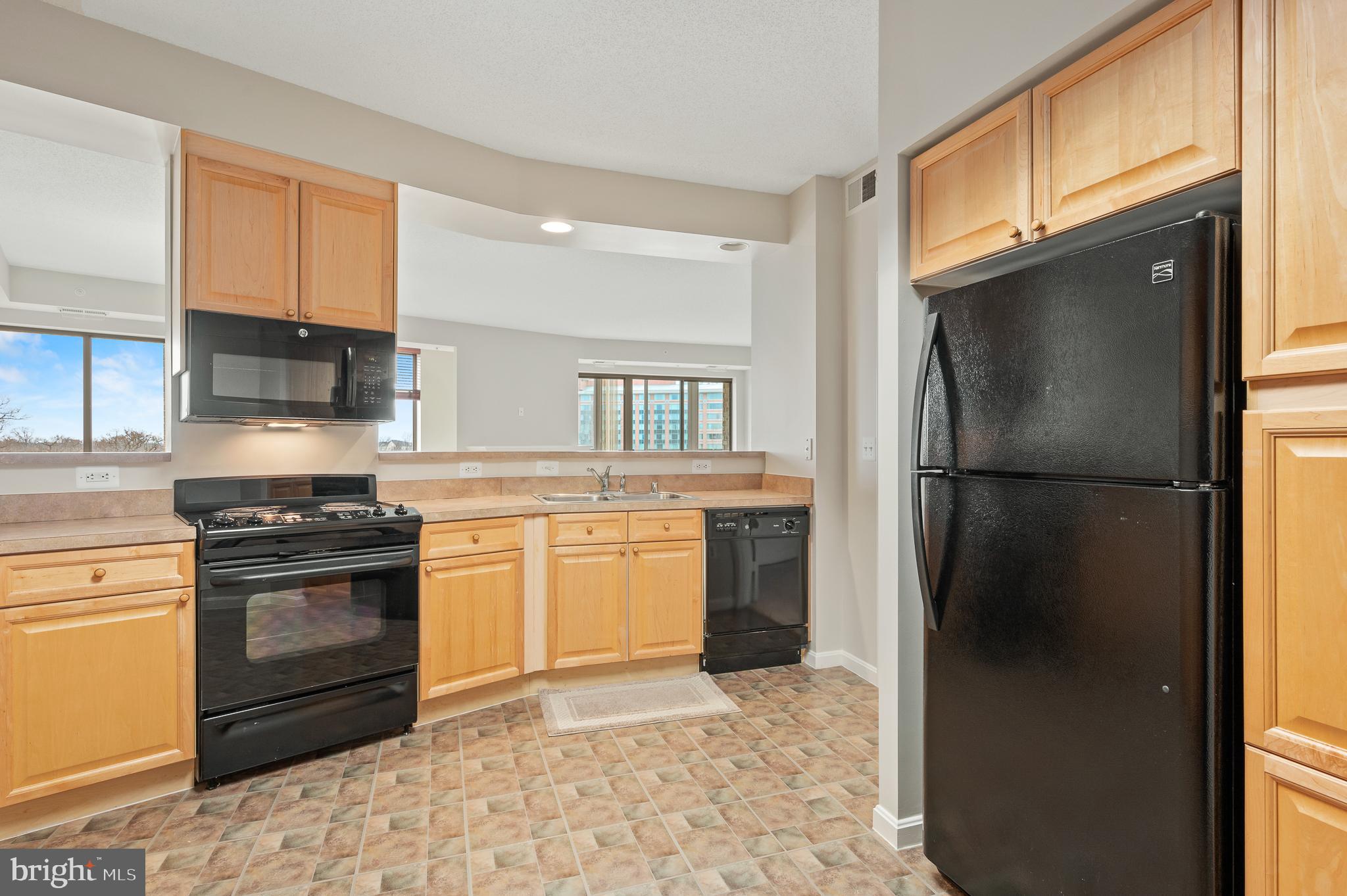 19355 Cypress Ridge Terrace, Unit 821 Leesburg, VA 20176 - Photo 13 of 27 a kitchen with a refrigerator sink and stove
