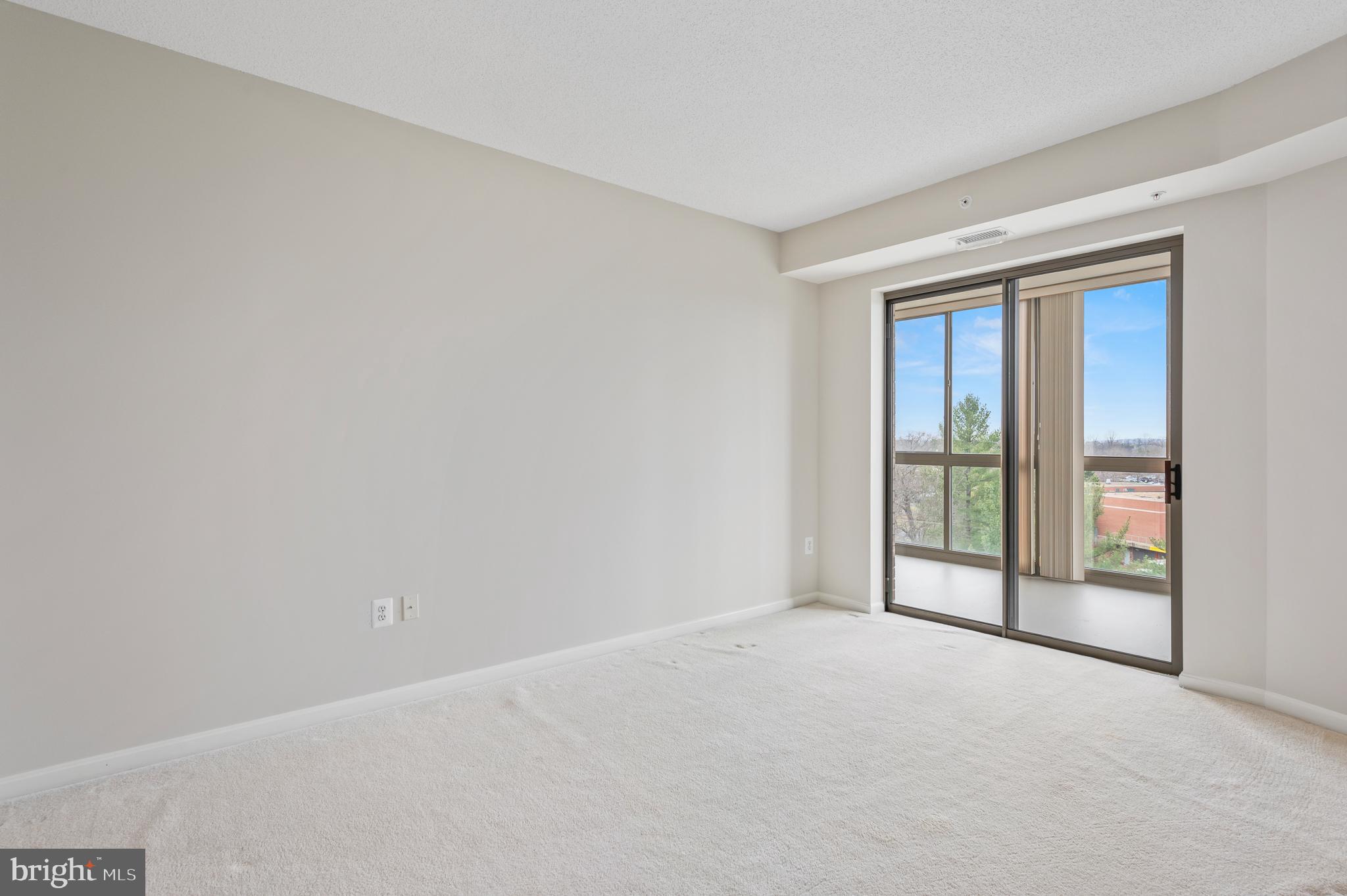 19355 Cypress Ridge Terrace, Unit 821 Leesburg, VA 20176 - Photo 18 of 27 a view of an empty room with glass door