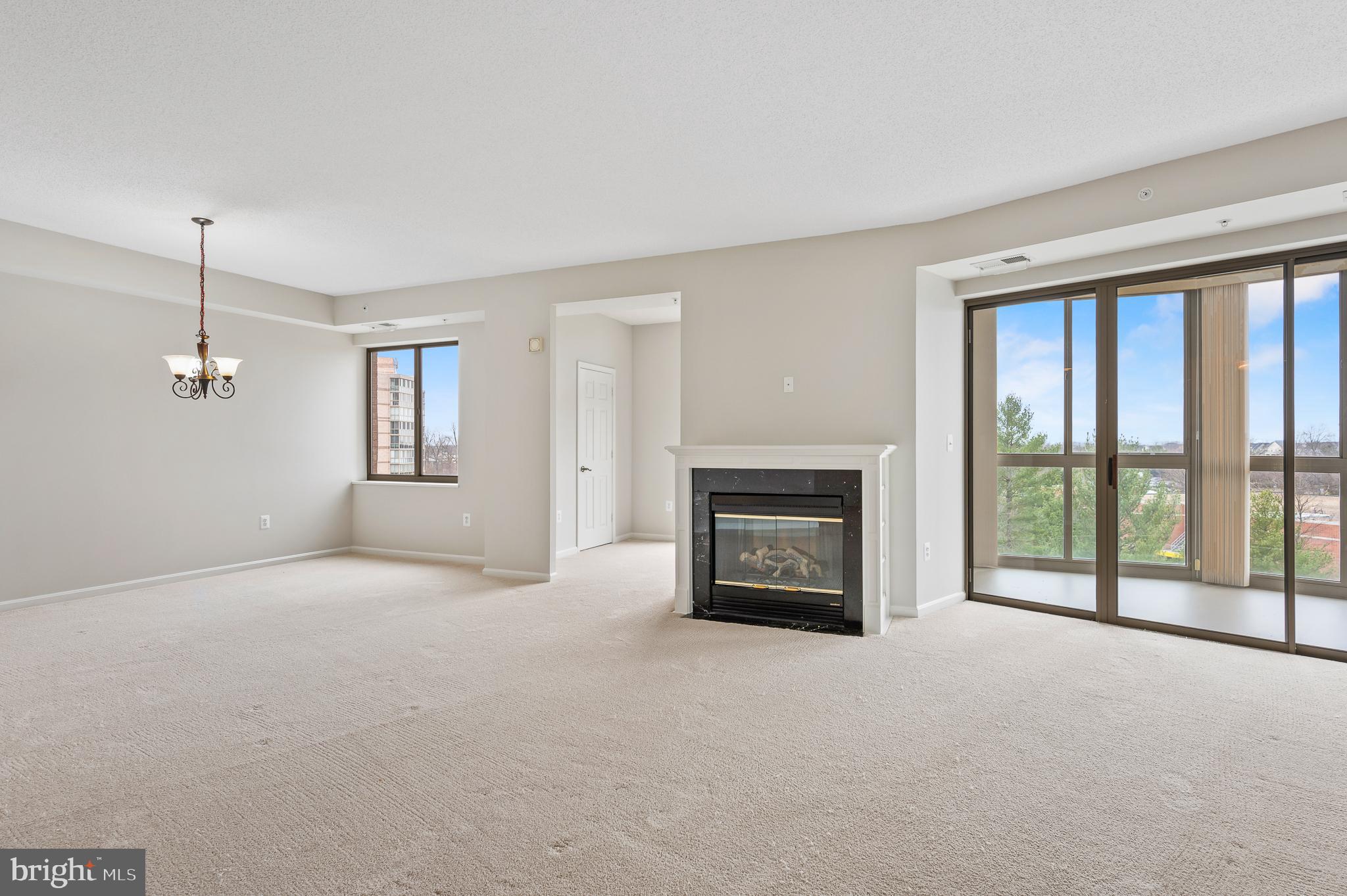 19355 Cypress Ridge Terrace, Unit 821 Leesburg, VA 20176 - Photo 4 of 27 a view of livingroom with fireplace large window and couch