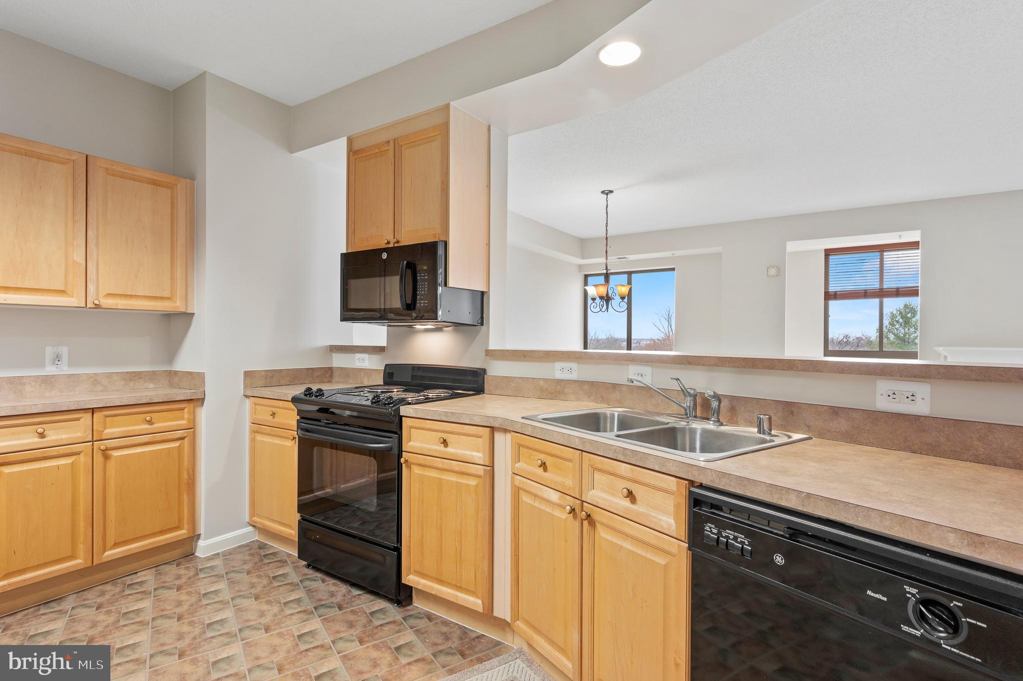 19355 Cypress Ridge Terrace, Unit 821 Leesburg, VA 20176 - Photo 10 of 27 a kitchen with stainless steel appliances granite countertop a sink stove and cabinets