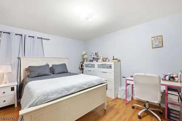 a bedroom with a bed and a chair in it