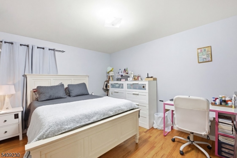 637 Jefferson Avenue Elizabeth, NJ 07201 - Photo 12 of 18 a bedroom with a bed and a chair in it
