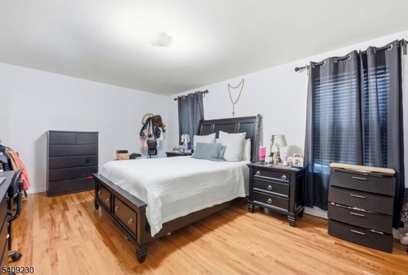 637 Jefferson Avenue Elizabeth, NJ 07201 - Photo 13 of 18 a bedroom with a bed and a flat tv screen on dresser
