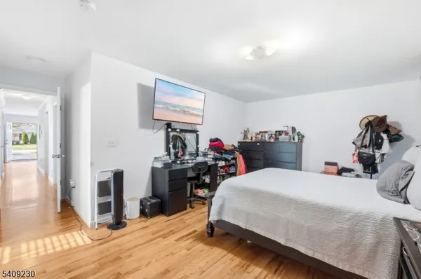 a bedroom with a bed and a tv