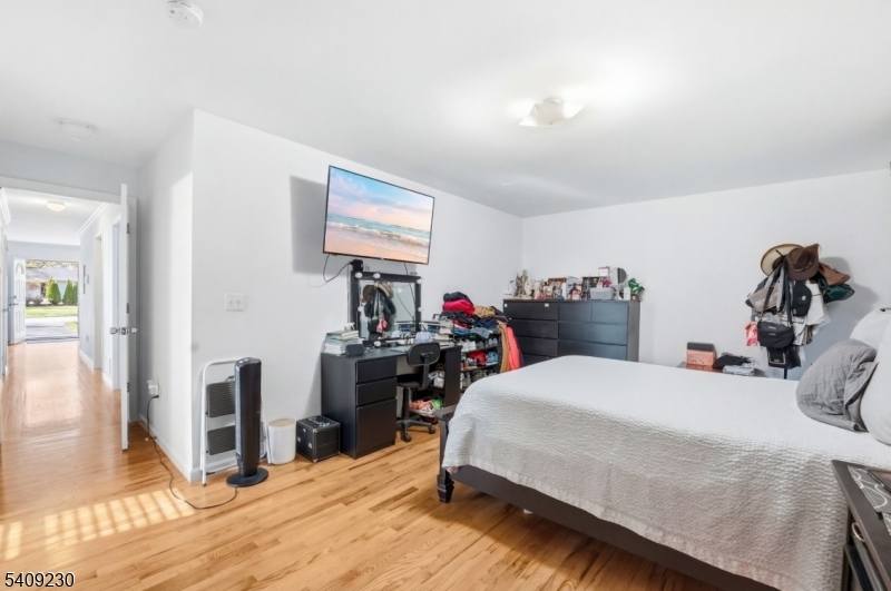 637 Jefferson Avenue Elizabeth, NJ 07201 - Photo 14 of 18 a bedroom with a bed and a tv
