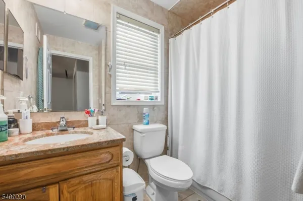 a bathroom with a toilet a sink and a mirror