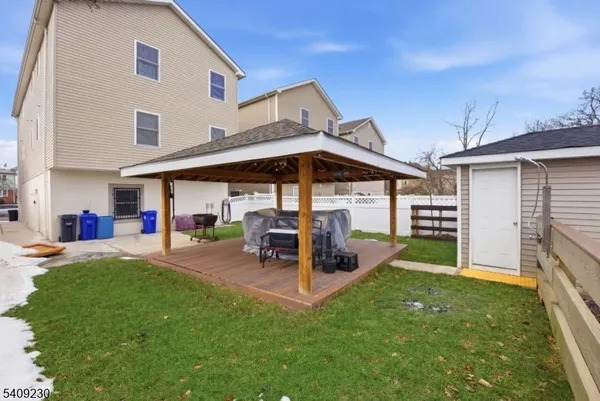 a view of a house with a yard and sitting area