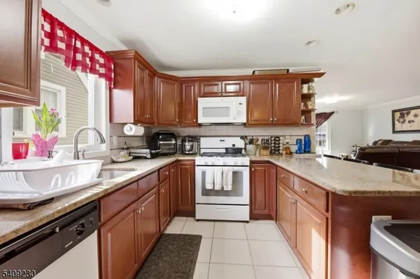 a kitchen with a sink stove top oven and cabinets