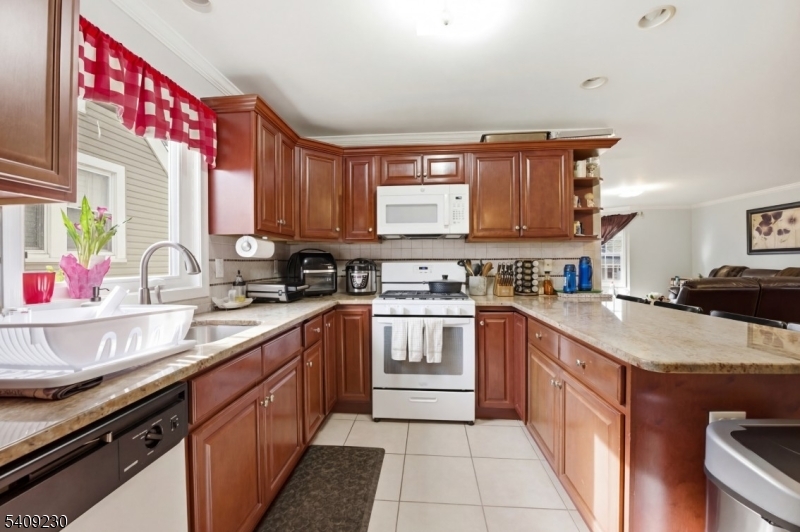 637 Jefferson Avenue Elizabeth, NJ 07201 - Photo 8 of 18 a kitchen with a sink stove top oven and cabinets