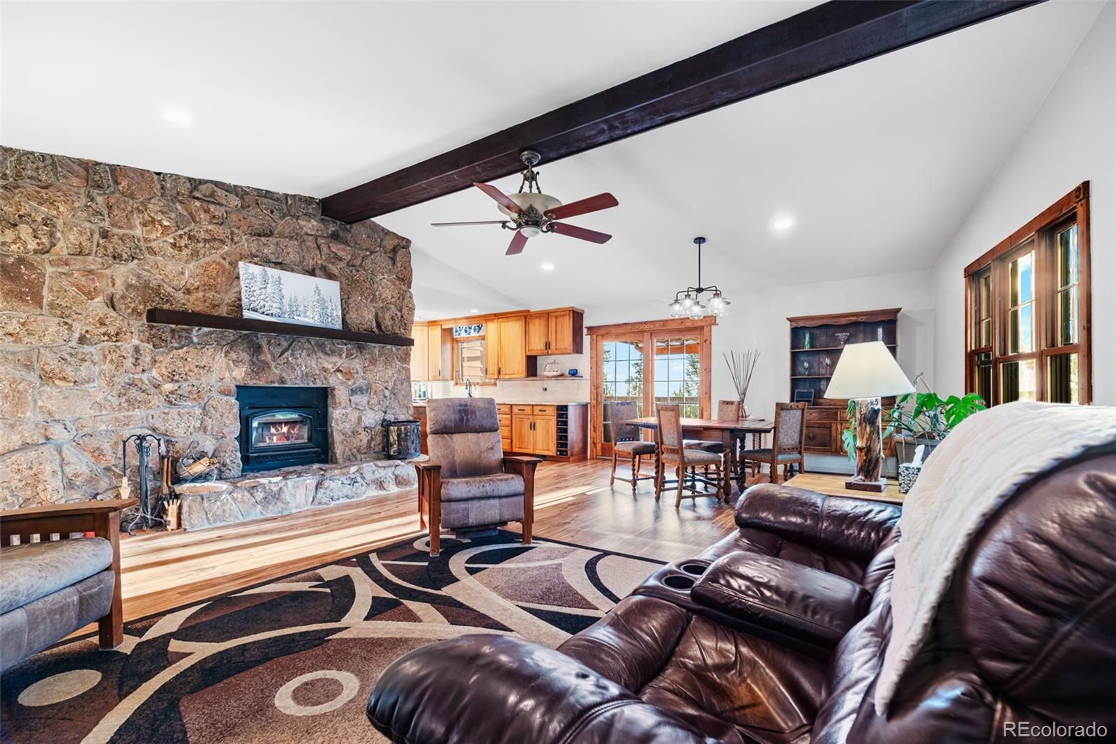 8440 South Warhawk Road Conifer, CO 80433 - Photo 13 of 48 a living room with furniture and a fireplace